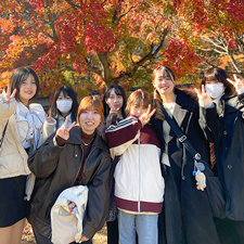 秋の校外授業にて紅葉の下で集合写真を撮る織田着物専門学校着物科学生